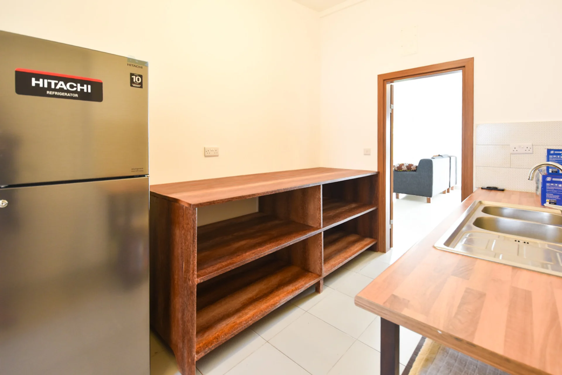 Refrigerator and open timber storage in the galley kitchen.