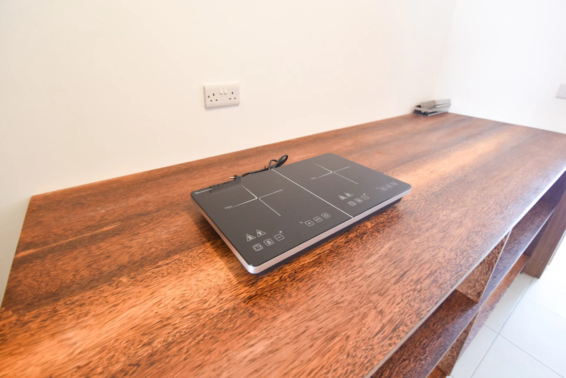 Portable induction hob on the kitchen timber worktop.